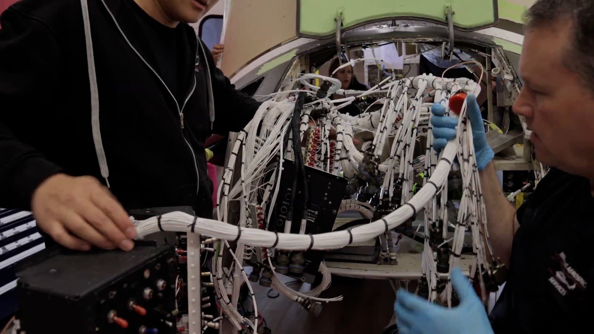 IAS technicians checking a new wiring harness during a Bell 412 rewire