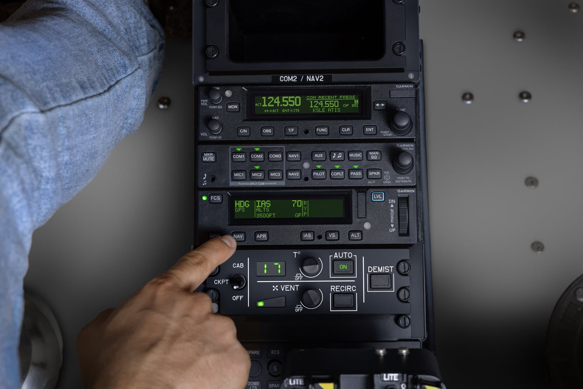 Technician operating a Garmin audio panel and radio stack