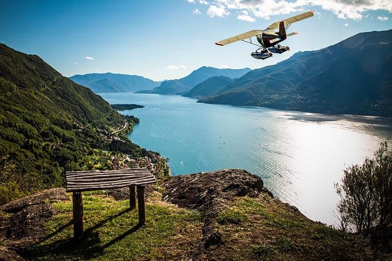 Seaplane in flight over a lake