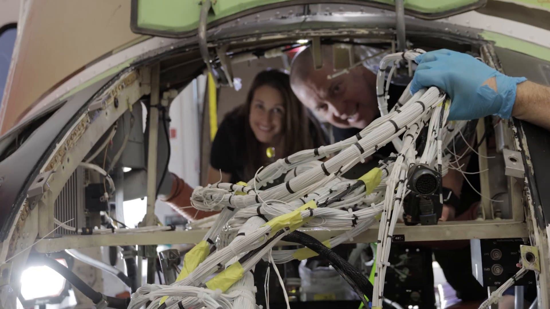 IAS team members looking through a newly built wiring harness during a Bell 412 rewire