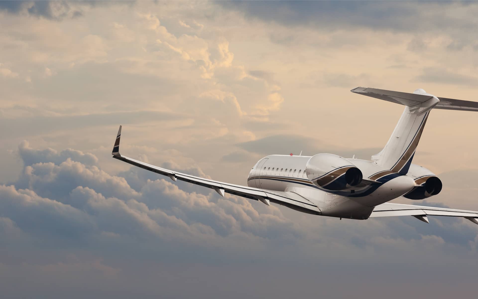 Corporate jet in flight above the clouds